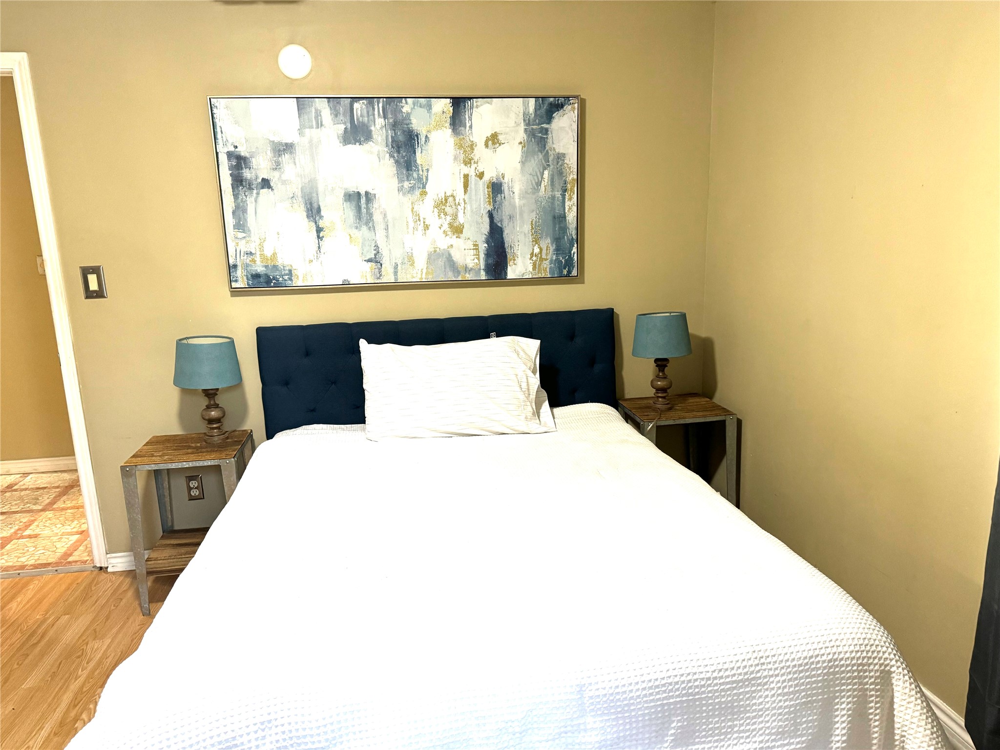 4812 Avenue G, Unit B Austin, TX 78751 - Photo 13 of 13 a bedroom with a bed and wooden floor