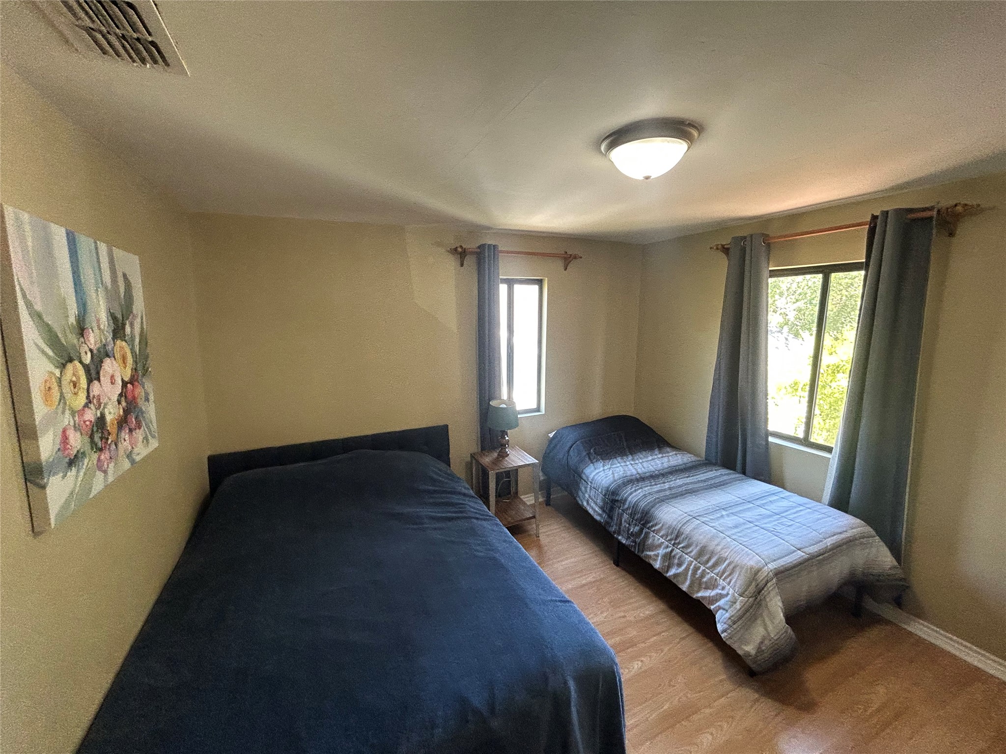 4812 Avenue G, Unit B Austin, TX 78751 - Photo 9 of 13 a bedroom with a bed lamp and window