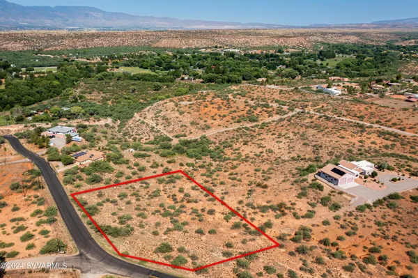 an aerial view of house with yard and mountain view in back