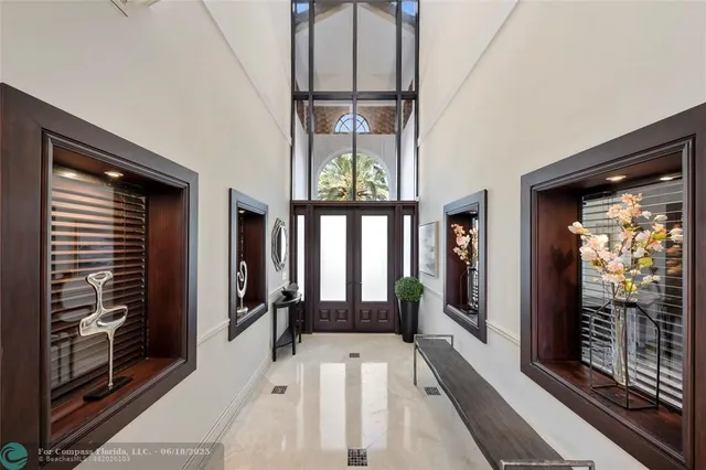 a living room with furniture a floor to ceiling window and stairs