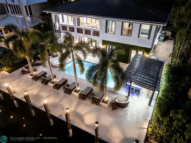 a view of a patio with couches table and chairs and potted plants