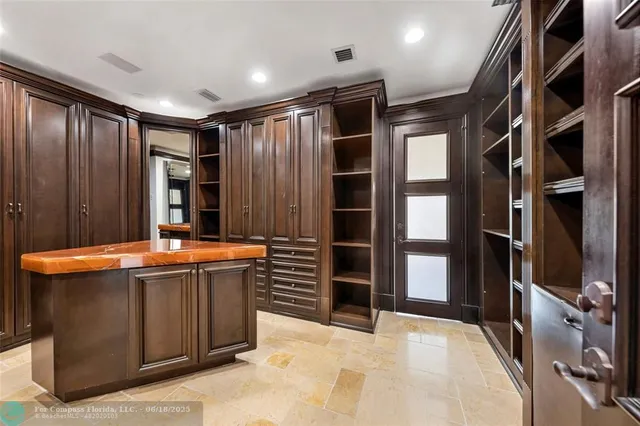 a living room with a bed furniture flat screen tv and a large window