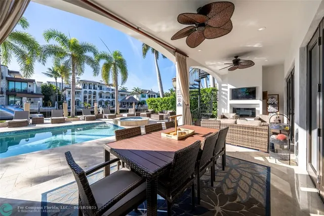 a view of swimming pool with a table and chairs