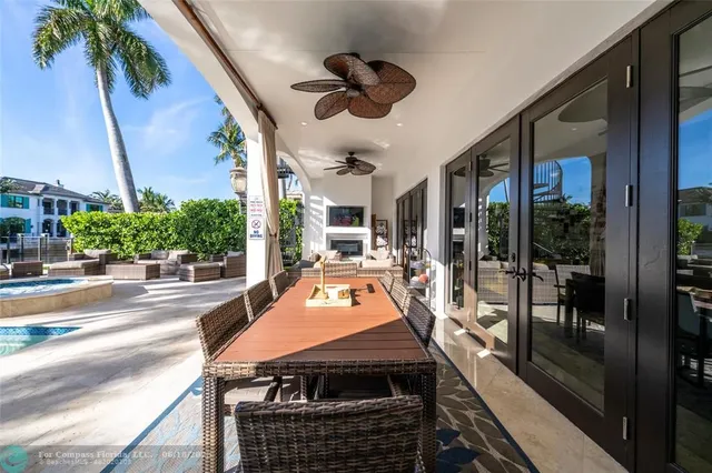 a view of a patio with table and chairs potted plants with wooden floor and fence