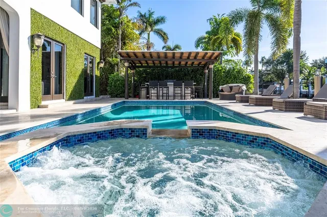 a view of a house with backyard porch and sitting area
