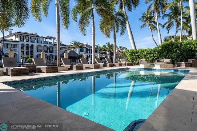 a view of swimming pool with outdoor seating and plants