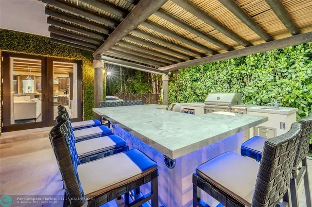 a hallway with painting on the wall and a large window