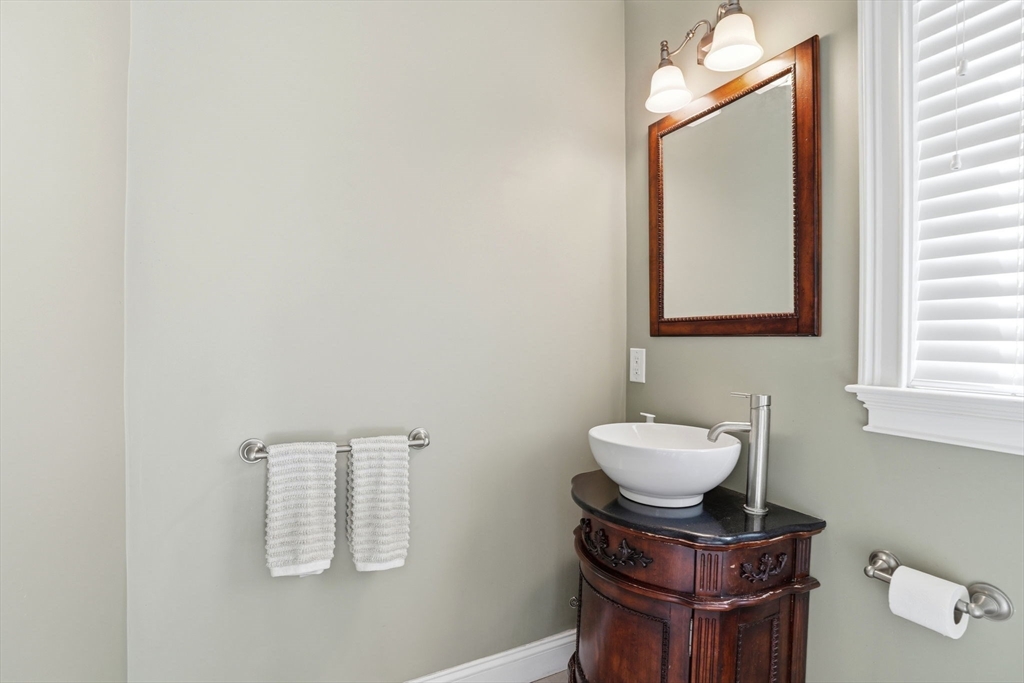 59 Elm Street Hingham, MA 02043 - Photo 15 of 33 a bathroom with a toilet a sink and mirror