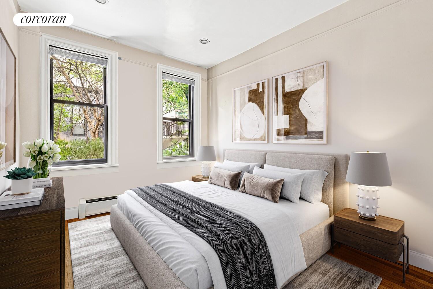 345 East 77th Street, Unit 3F Manhattan, NY 10075 - Photo 2 of 5 a bedroom with a bed a painting and a window