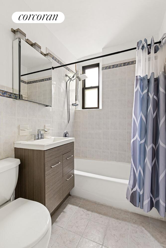 345 East 77th Street, Unit 3F Manhattan, NY 10075 - Photo 4 of 5 a bathroom with a sink vanity mirror and toilet