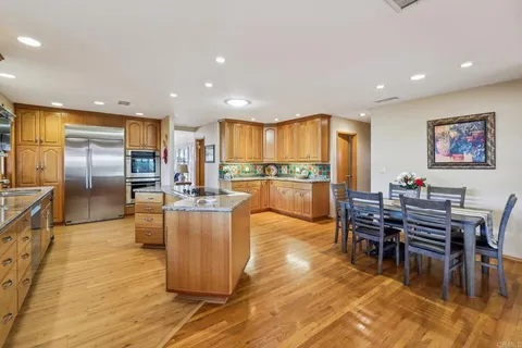 a kitchen with granite countertop a sink cabinets and wooden floor