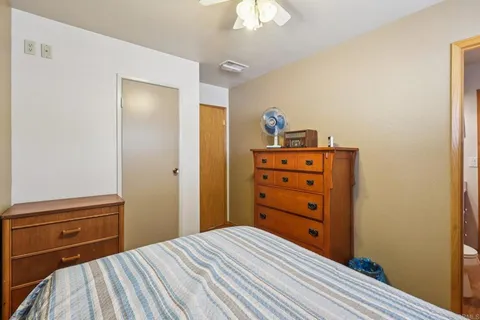 a view of a hallway with wooden floor and closet