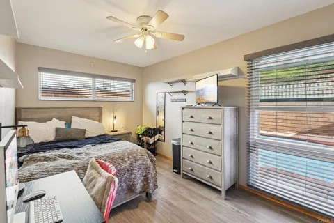 a bedroom with a bed and a chandelier