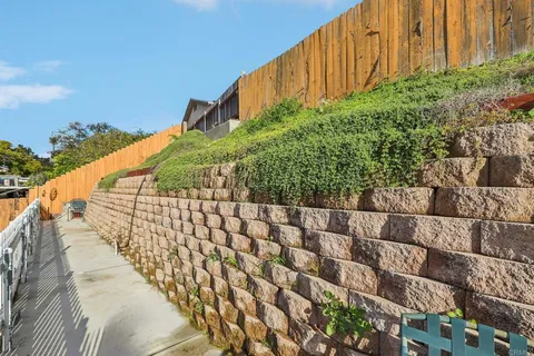 a front view of a house with cars parked