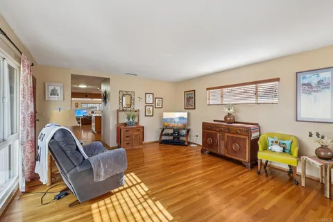 a living room with furniture and a floor to ceiling window