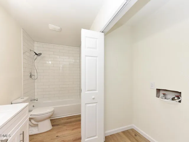 a bathroom with a toilet a sink and shower