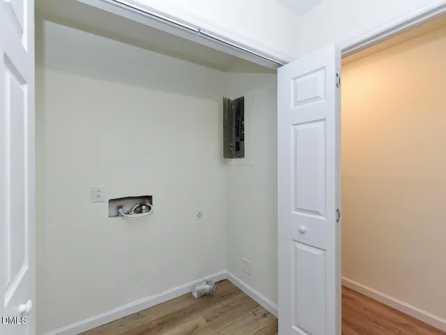 a view of a room with wooden floor