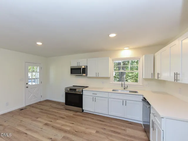 a kitchen with a sink stove and cabinets