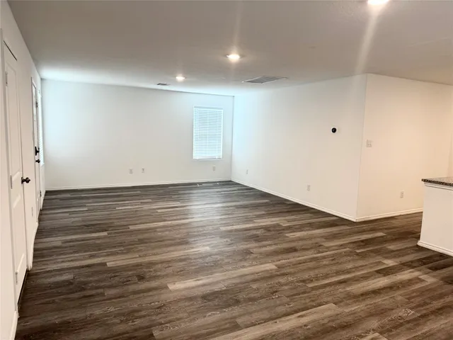 an empty room with wooden floor