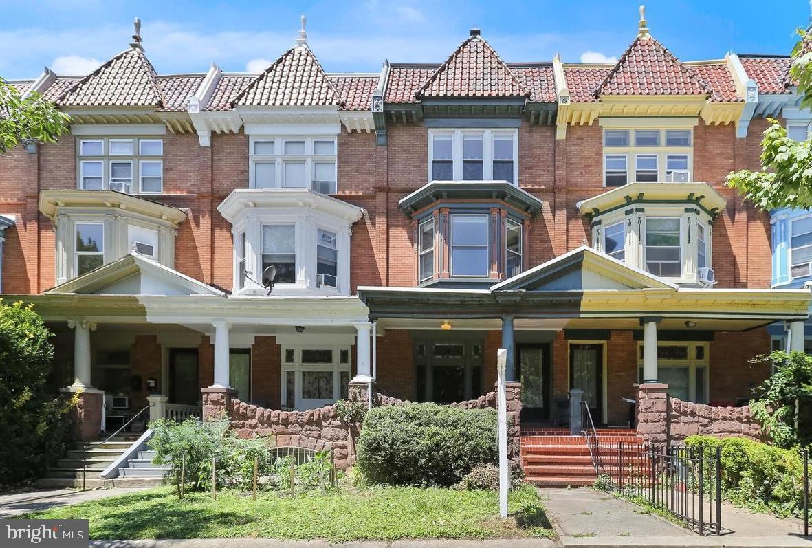 a front view of a residential apartment building with a yard