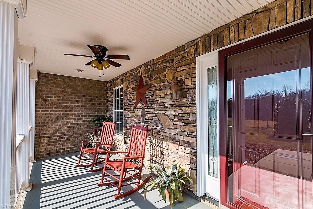 8315 Dennis Road Walnut Cove, NC 27052 - Photo 12 of 30 Cozy Rocking Chair Front Porch w/Stone Wall