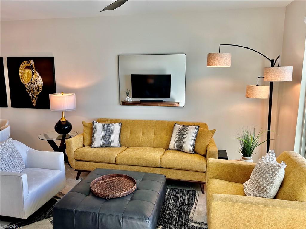 43989 Boardwalk Loop, Unit 2024 Babcock Ranch, FL 33982 - Photo 2 of 18 a living room with furniture and a flat screen tv