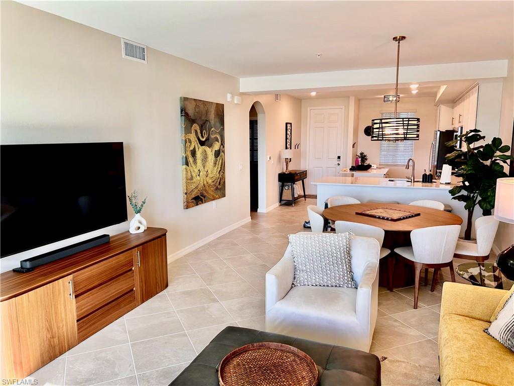 43989 Boardwalk Loop, Unit 2024 Babcock Ranch, FL 33982 - Photo 3 of 18 a living room with furniture and a flat screen tv