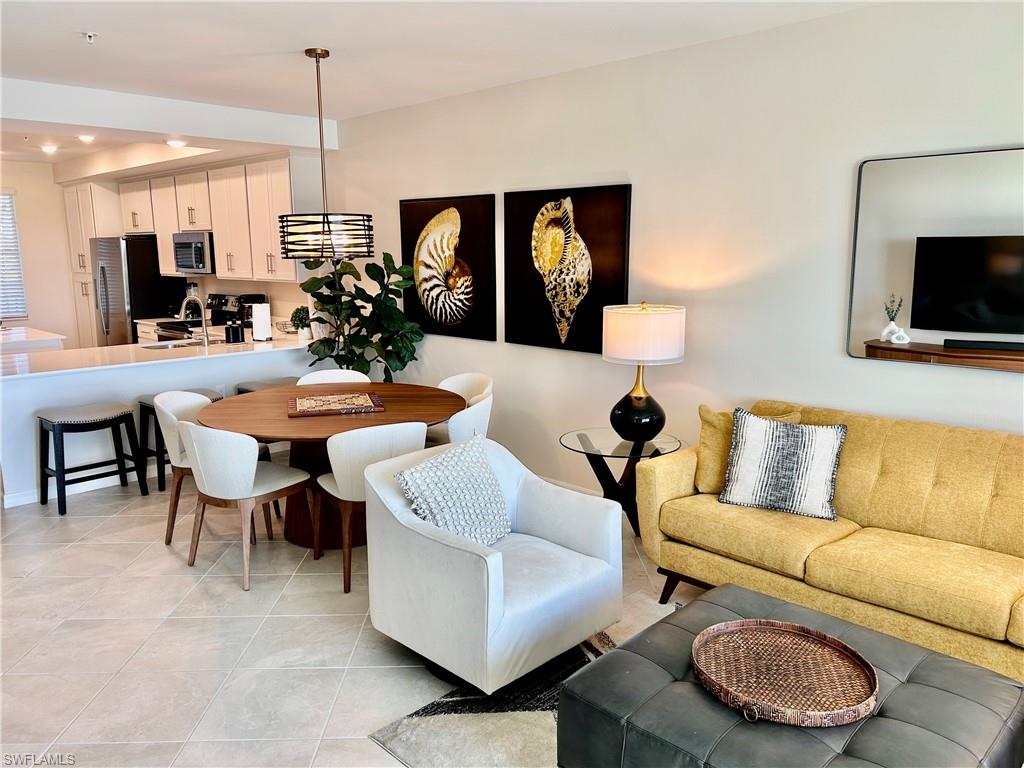 43989 Boardwalk Loop, Unit 2024 Babcock Ranch, FL 33982 - Photo 4 of 18 a living room with furniture kitchen view and a wooden floor
