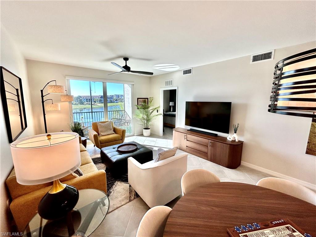 43989 Boardwalk Loop, Unit 2024 Babcock Ranch, FL 33982 - Photo 5 of 18 a living room with furniture and a flat screen tv
