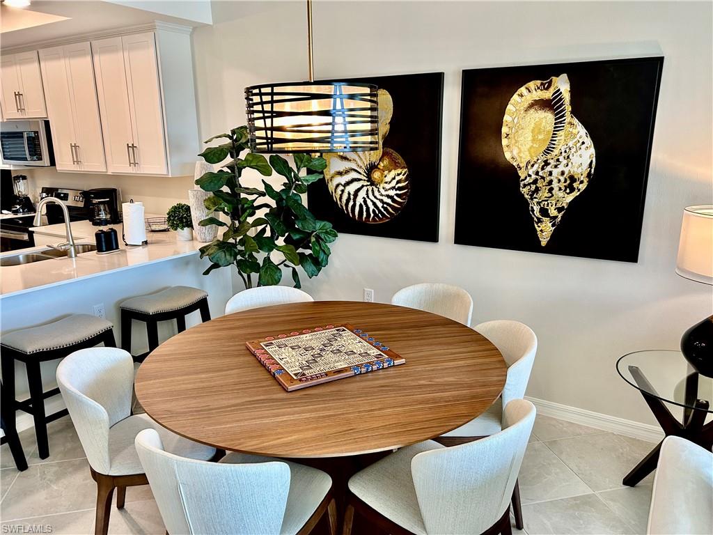 43989 Boardwalk Loop, Unit 2024 Babcock Ranch, FL 33982 - Photo 7 of 18 a dining room with furniture and wooden floor