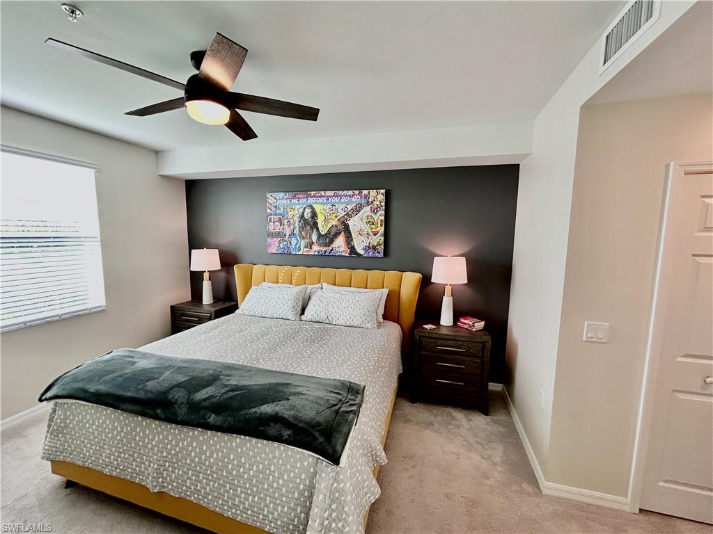 43989 Boardwalk Loop, Unit 2024 Babcock Ranch, FL 33982 - Photo 10 of 18 a bedroom with a bed and a walk in closet