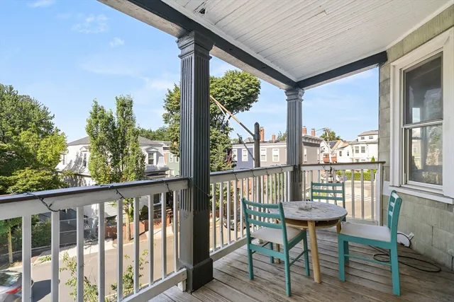 a view of a chairs and table in the balcony