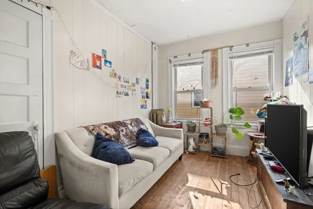 a living room with furniture rug and a window
