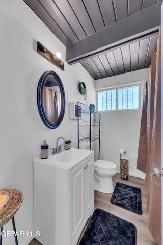 a bathroom with a toilet a sink and a mirror