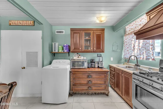 a kitchen with a stove and a refrigerator