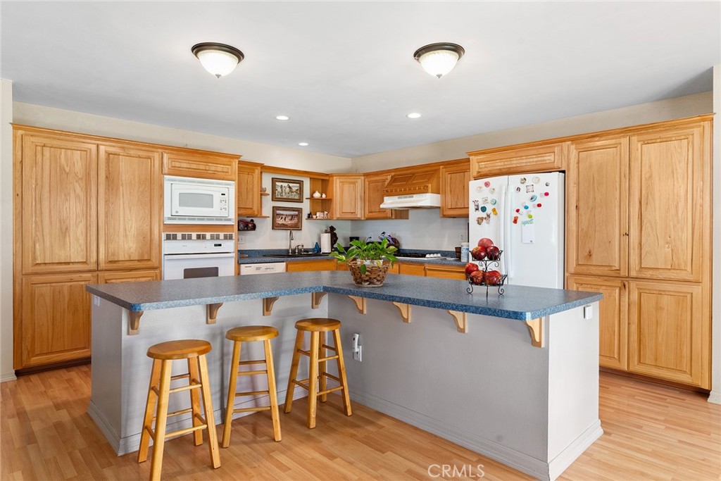 5735 Lunt Road Yankee Hill, CA 95965 - Photo 11 of 48 a kitchen with stainless steel appliances a table and chairs in it
