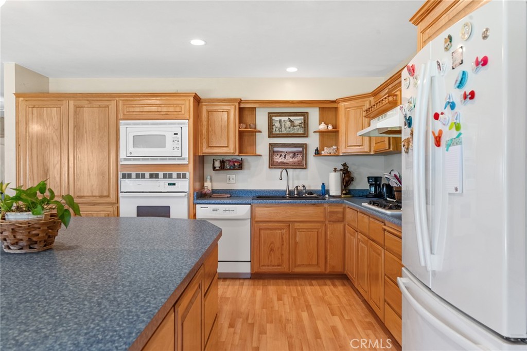 5735 Lunt Road Yankee Hill, CA 95965 - Photo 12 of 48 a kitchen with stainless steel appliances granite countertop a stove a sink and a refrigerator