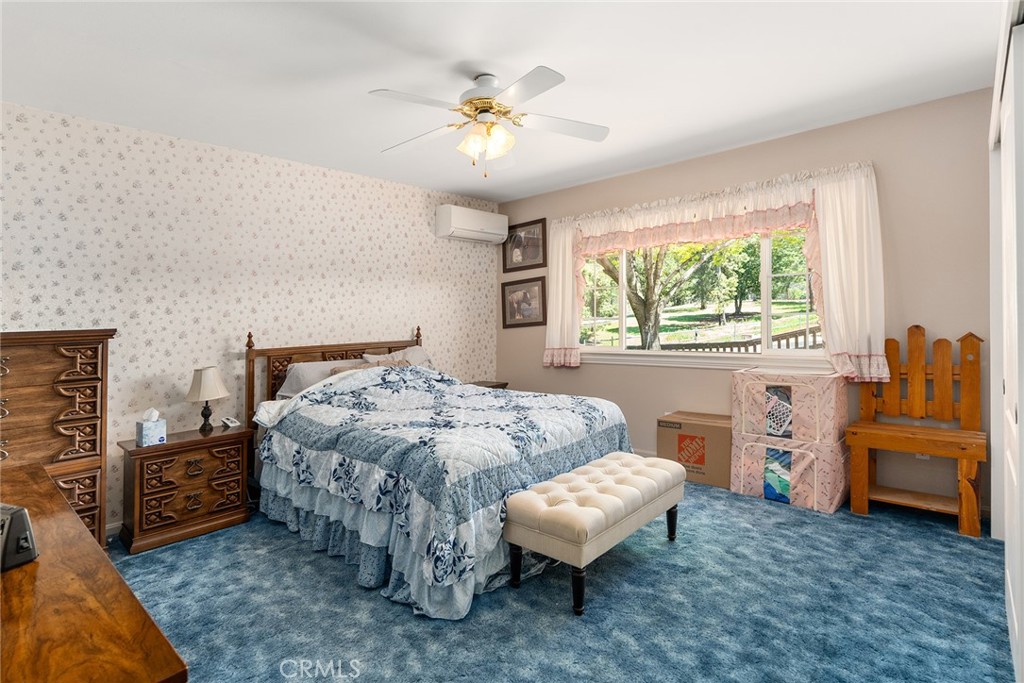 5735 Lunt Road Yankee Hill, CA 95965 - Photo 14 of 48 a bedroom with a bed and a chandelier