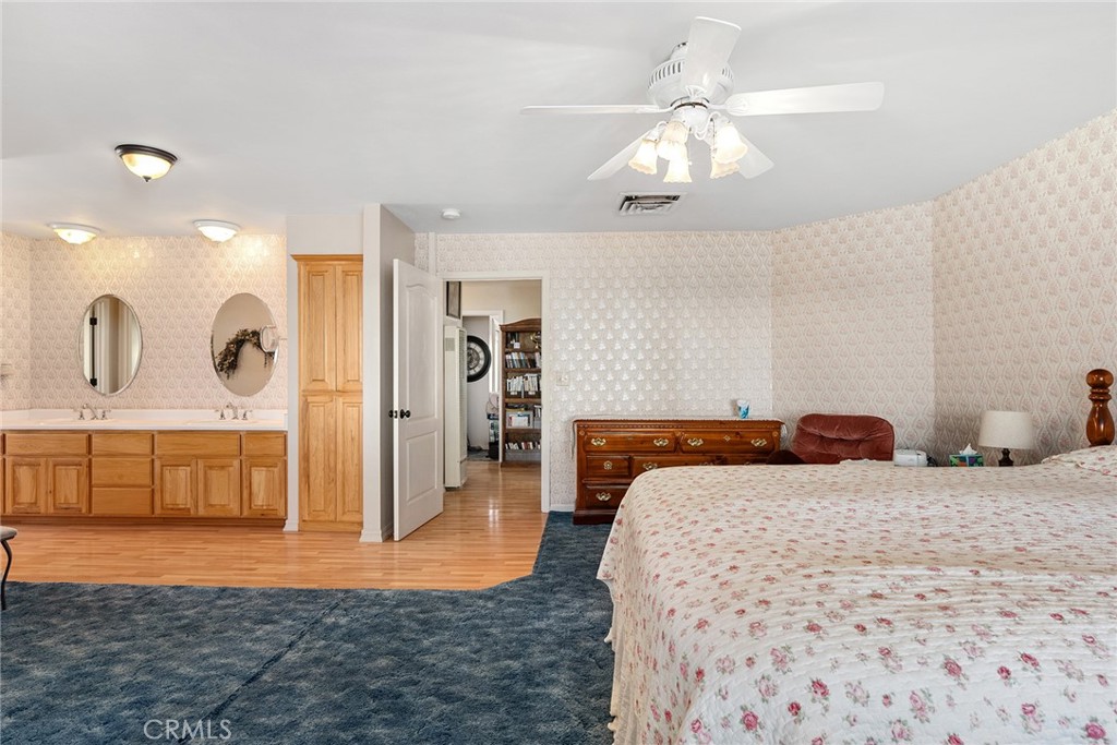 5735 Lunt Road Yankee Hill, CA 95965 - Photo 23 of 48 a bedroom with a large bed and a chandelier