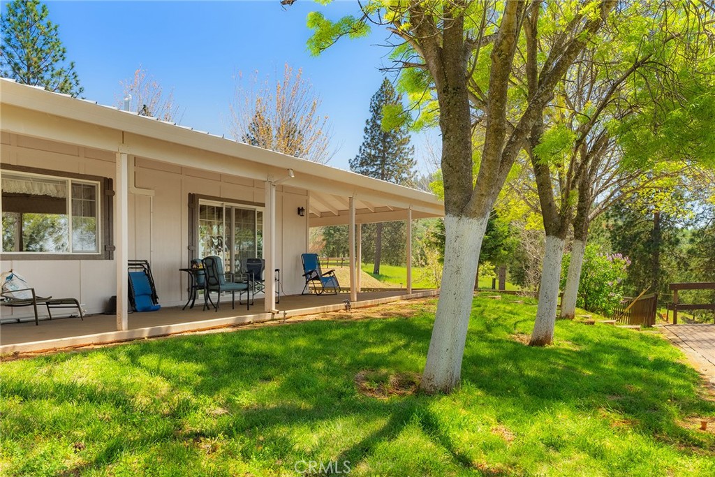 5735 Lunt Road Yankee Hill, CA 95965 - Photo 28 of 48 a view of a patio with table and chairs and potted plants with large tree