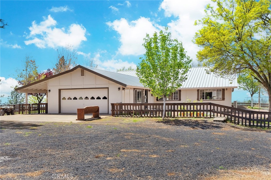 5735 Lunt Road Yankee Hill, CA 95965 - Photo 10 of 48 a view of a house with wooden fence next to a road