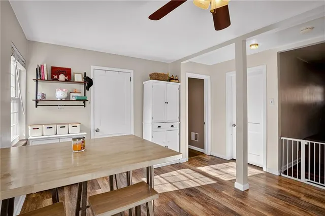 a living room with kitchen island furniture and wooden floor