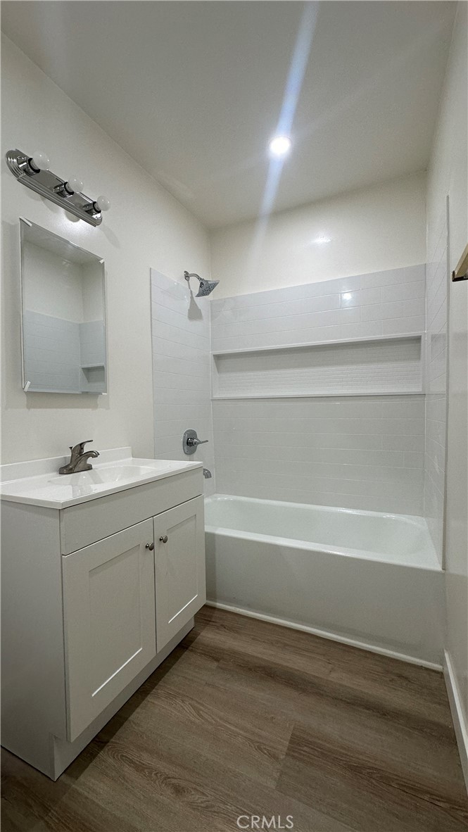 525 Howard Street, Unit F Alhambra, CA 91801 - Photo 6 of 8 a bathroom with a tub sink double vanity and mirror