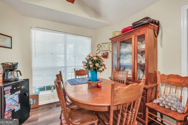 a dining room with furniture and window