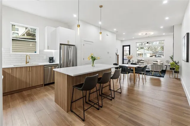 a kitchen with stainless steel appliances a stove a white cabinet a microwave and a white cabinets