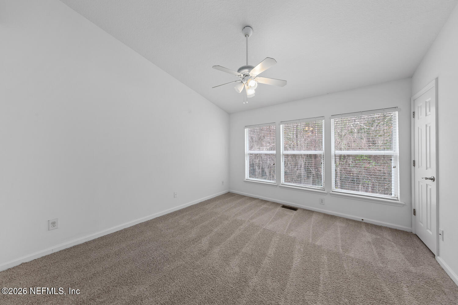 3532 Twisted Tree Lane Jacksonville, FL 32216 - Photo 12 of 23 an empty room with chandelier fan and windows