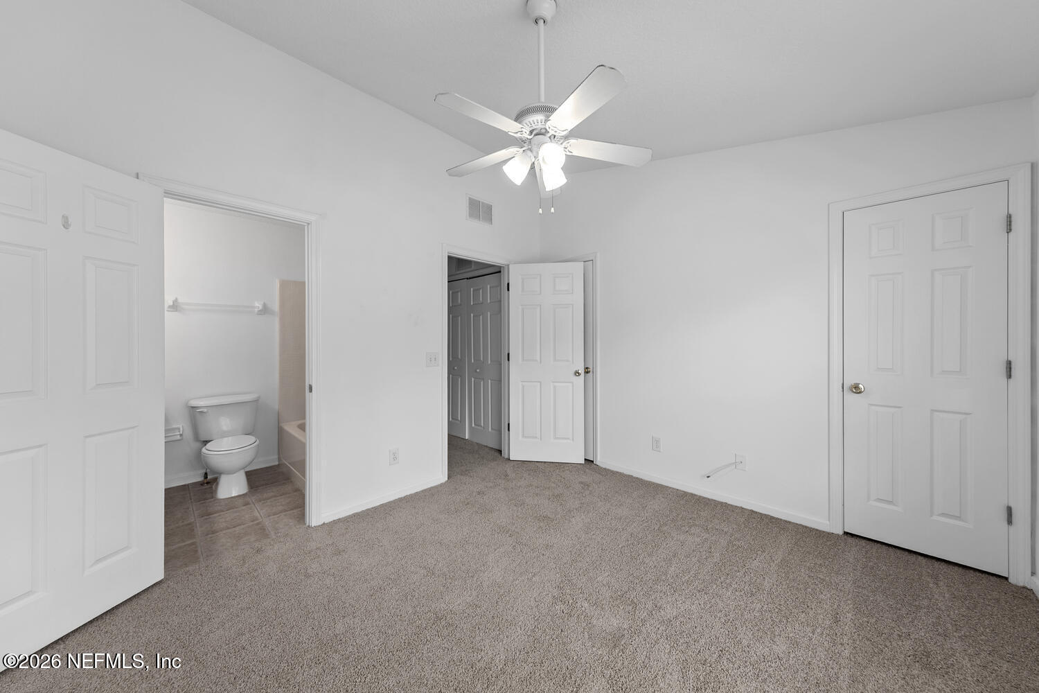 3532 Twisted Tree Lane Jacksonville, FL 32216 - Photo 17 of 23 a view of a room with a ceiling fan and a bathroom