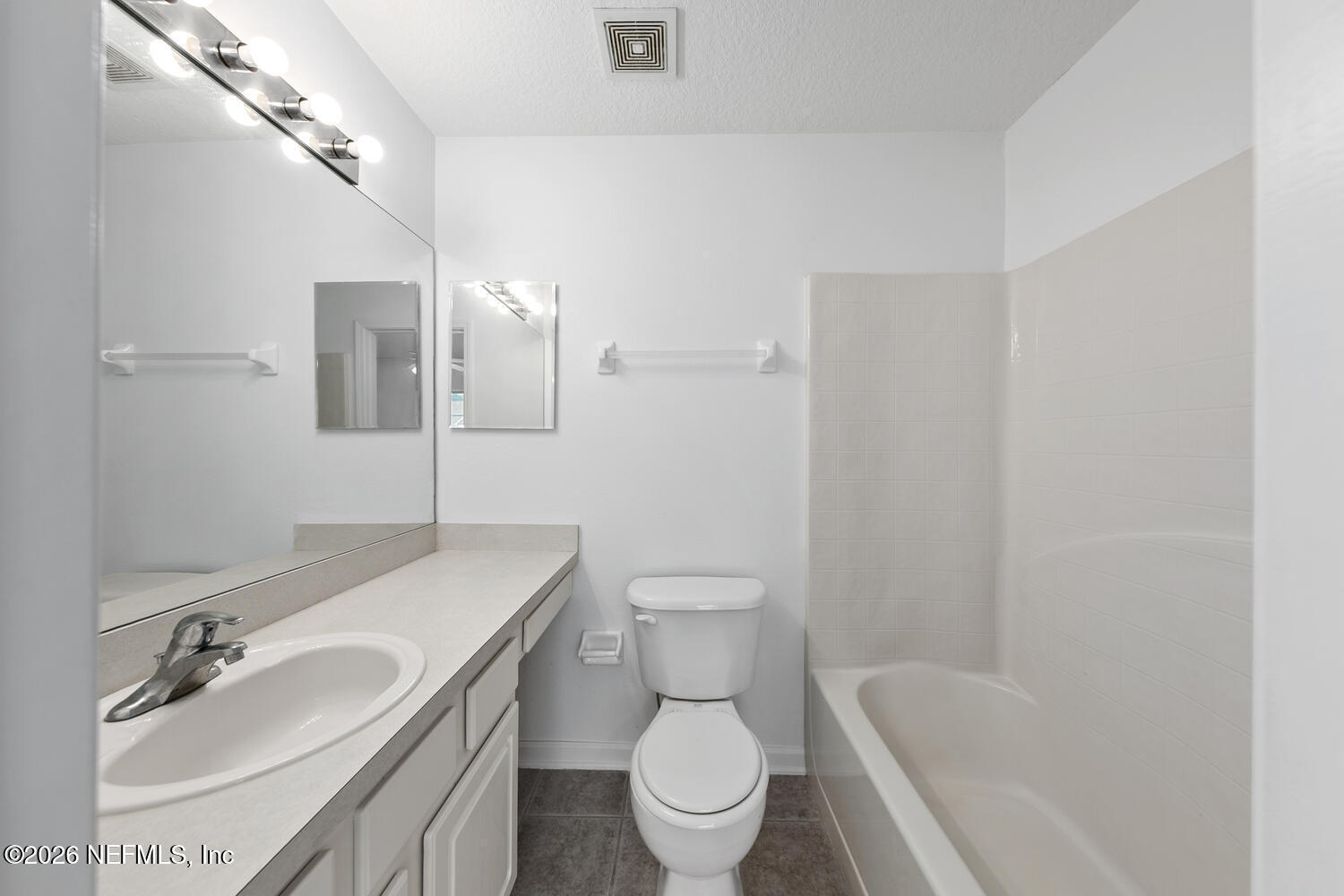 3532 Twisted Tree Lane Jacksonville, FL 32216 - Photo 18 of 23 a bathroom with a granite countertop sink a toilet and a mirror