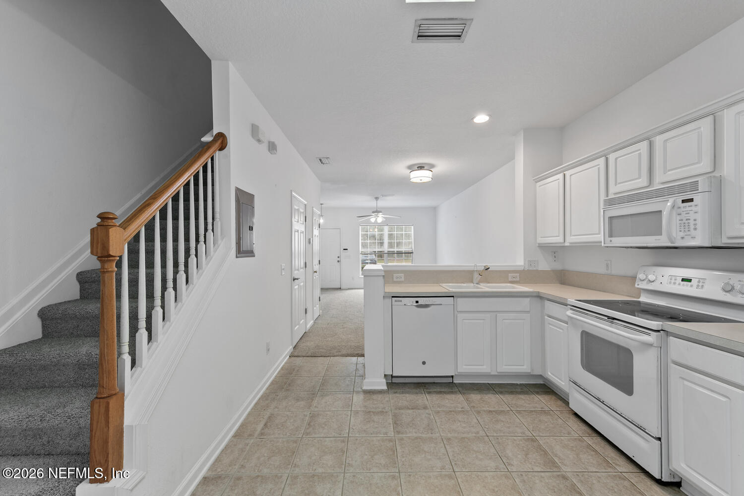 3532 Twisted Tree Lane Jacksonville, FL 32216 - Photo 4 of 23 a kitchen with white cabinets appliances and a sink