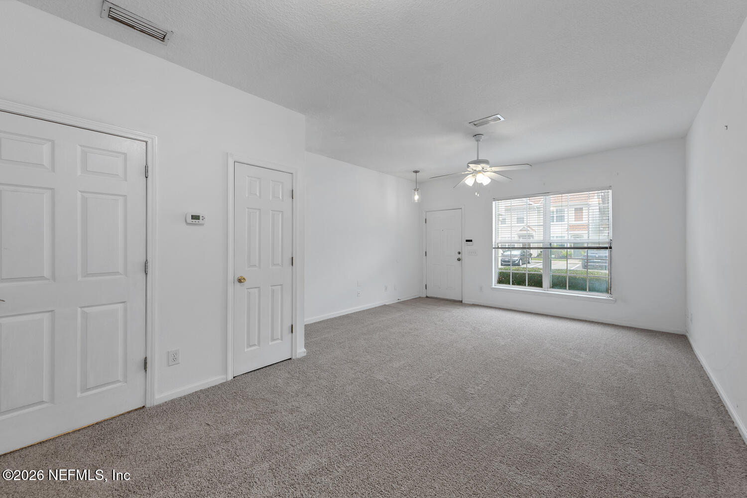 3532 Twisted Tree Lane Jacksonville, FL 32216 - Photo 6 of 23 a view of a big room with windows and chandelier fan